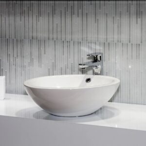white faucet in a black-themed room