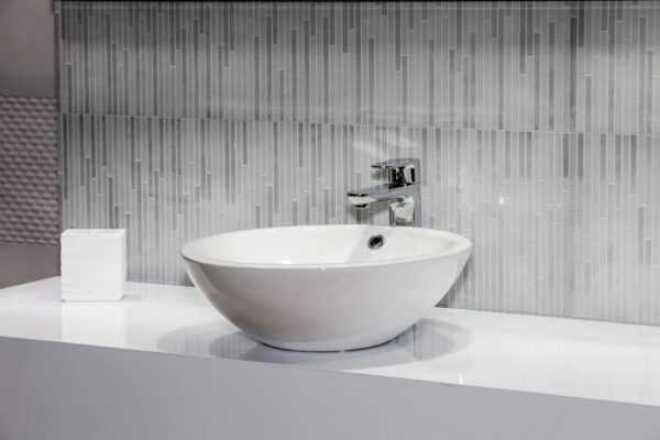 white faucet in a black-themed room