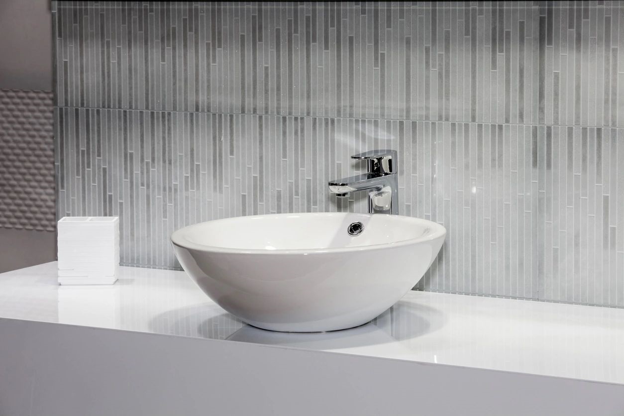 white faucet in a black-themed room